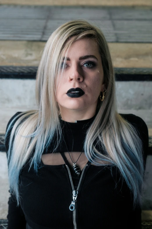 a woman with long blonde hair and black lipstick