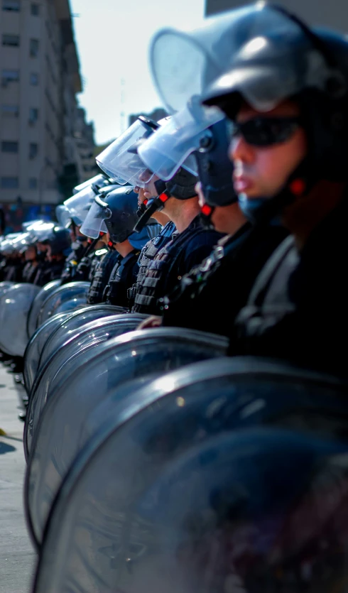 a row of police officers in uniform line up against a line