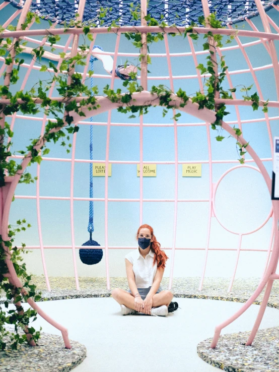 a girl in white shirt sitting on the ground