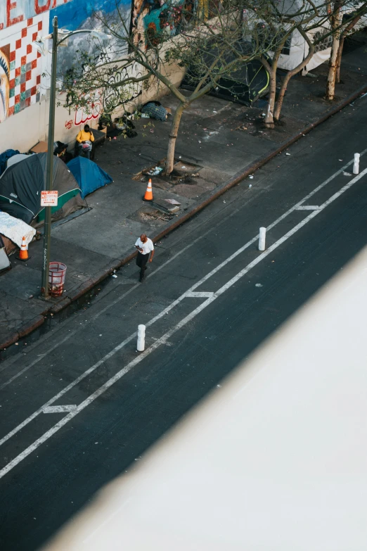 a street scene with tents, a man and a woman on the side walk