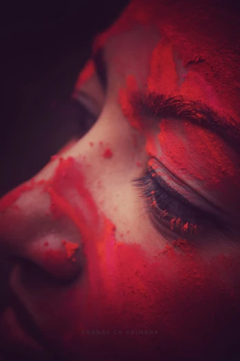 a woman with red paint smeared on her face