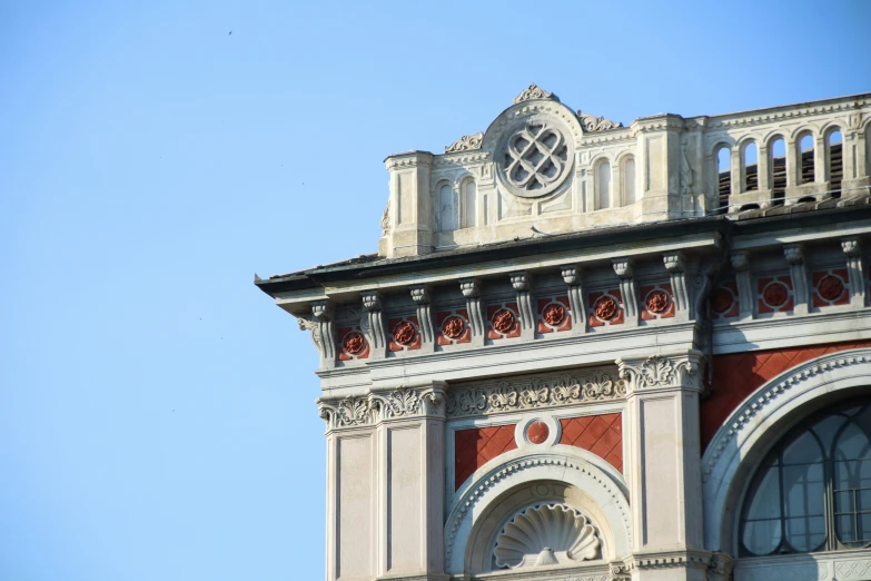 a tall red brick tower with an elaborate clock