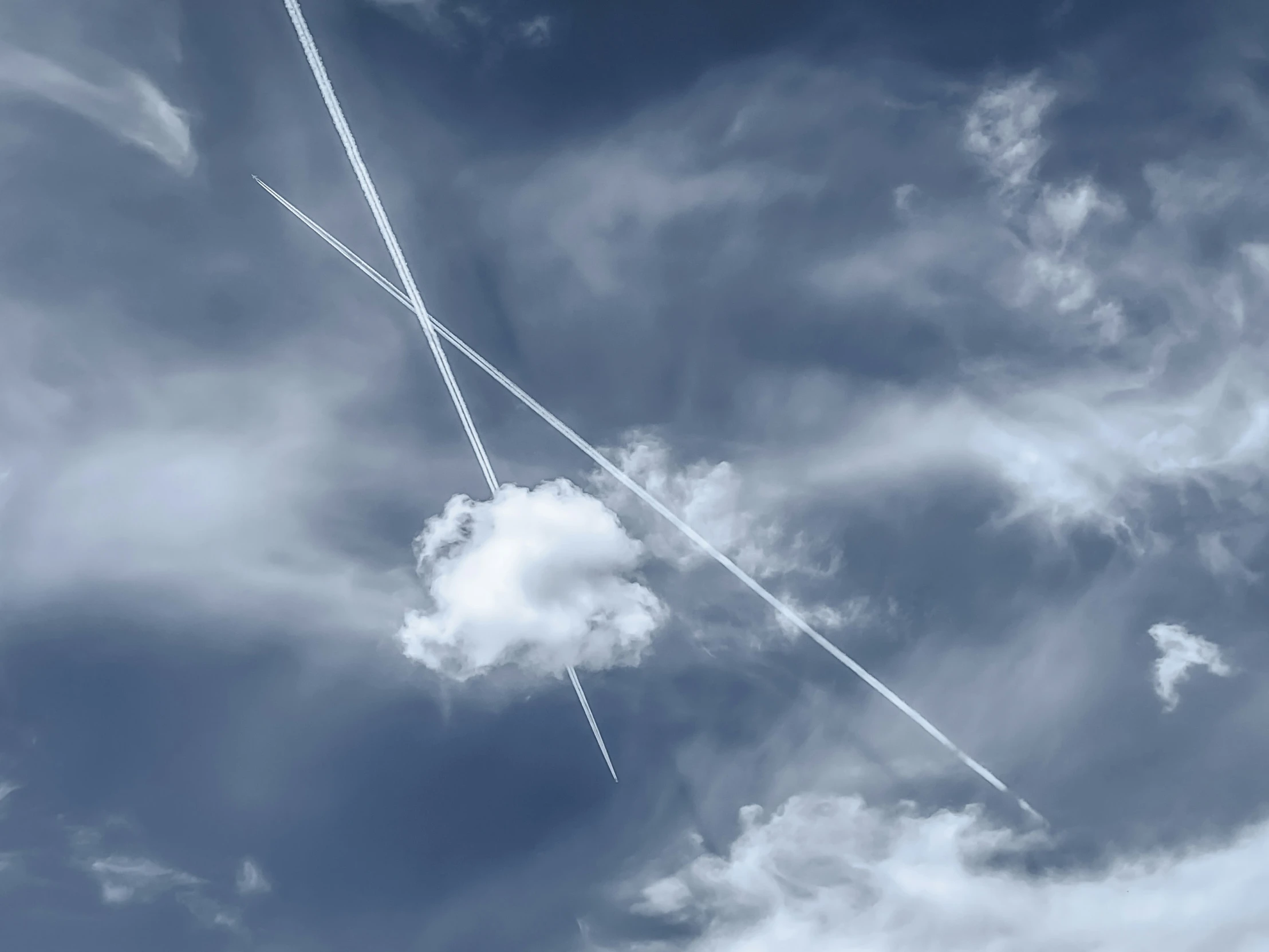 two airplanes are flying in formation with one long tail