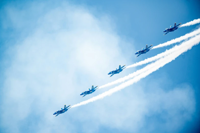 four jets flying high in the air making contrails