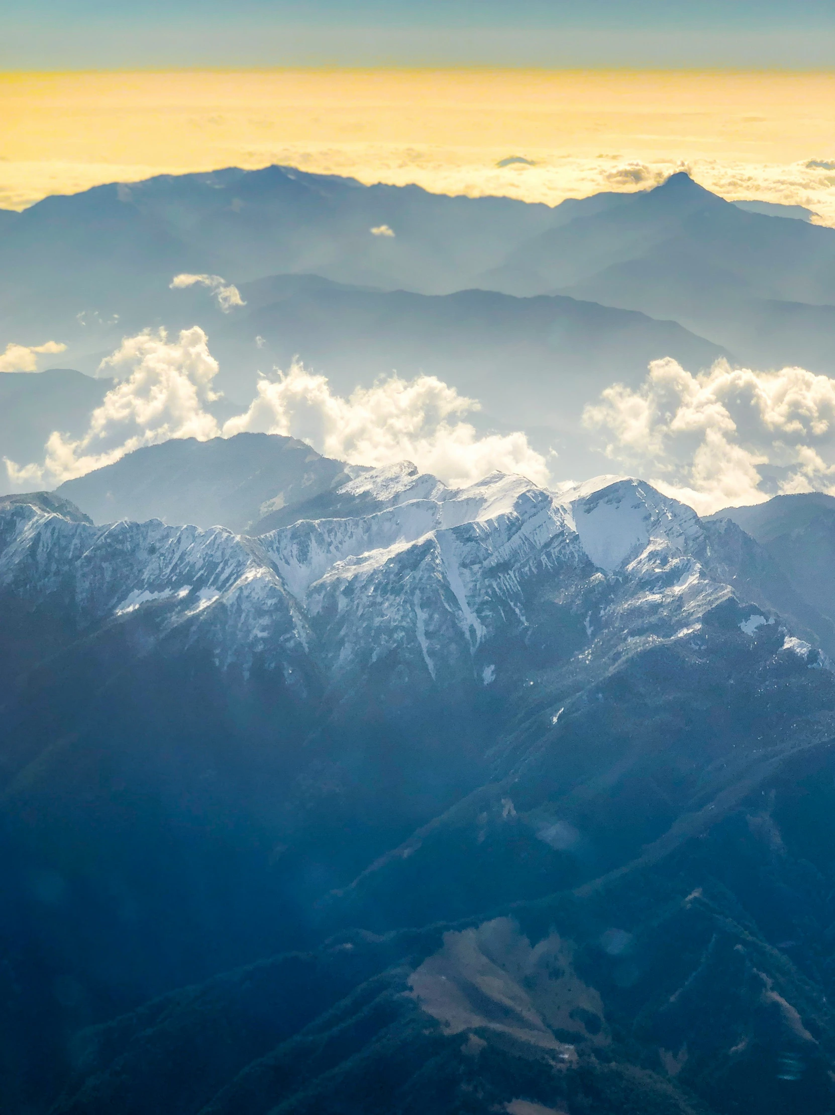 looking out the airplane window at mountains in the distance