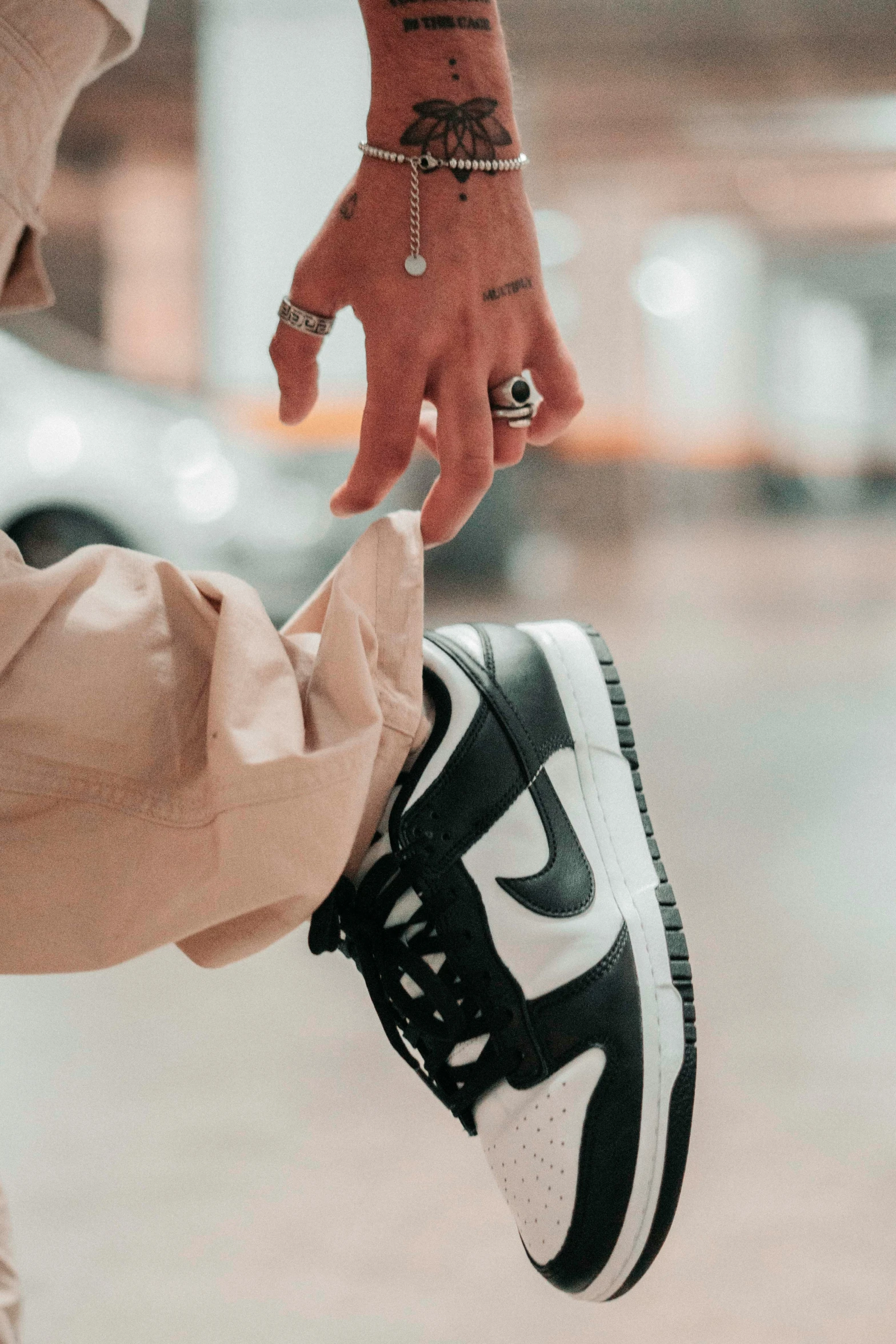 a woman holds the toe of a persons shoe