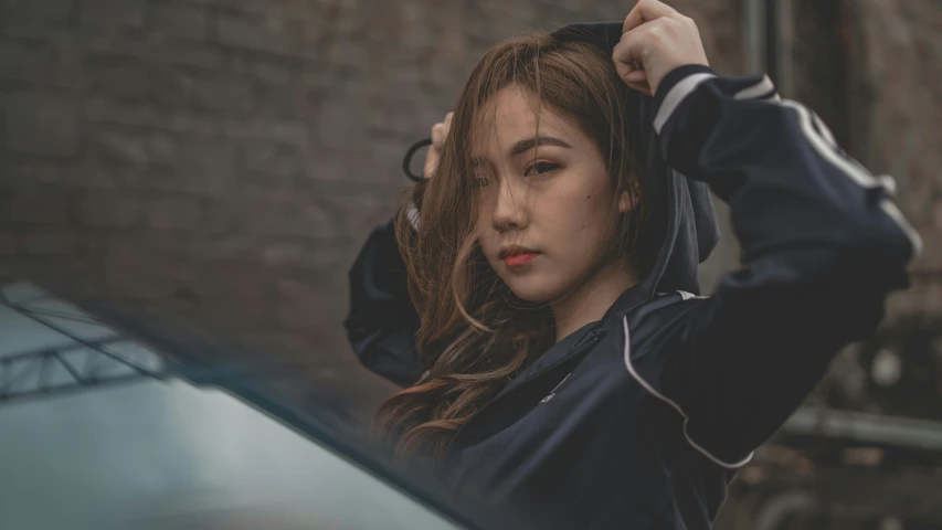 a girl standing by a car holding a umbrella