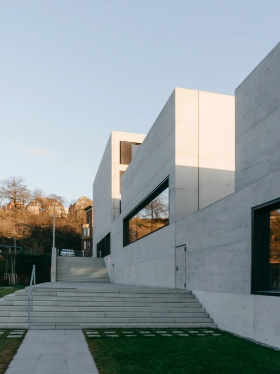 a stone staircase next to a building with windows