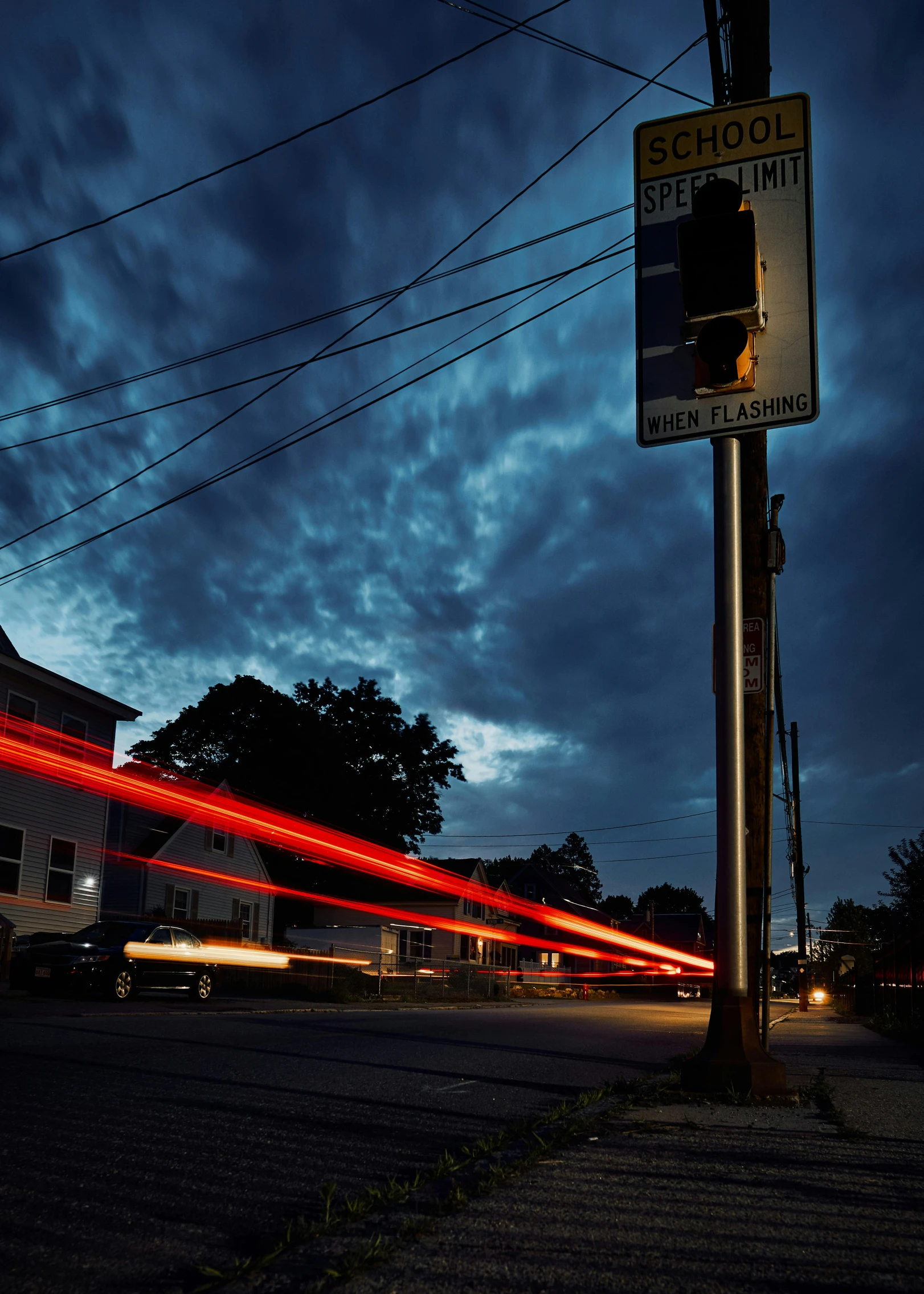 a city street with cars passing by and stop lights