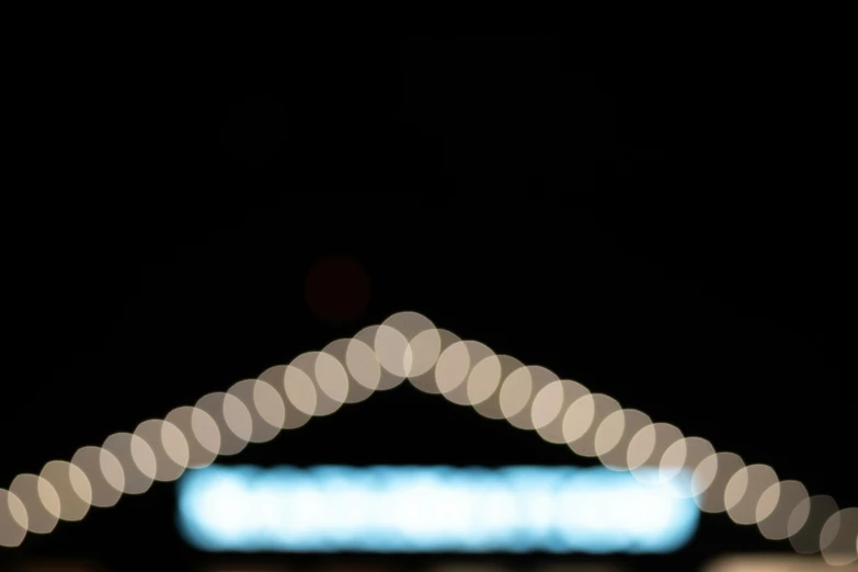 blurred lights are in the dark, and a blurry object