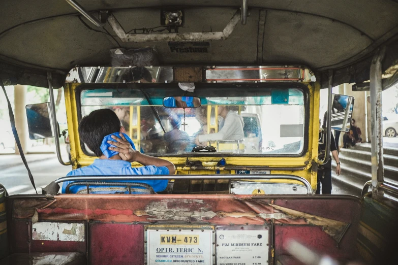 an indian woman driving a small truck