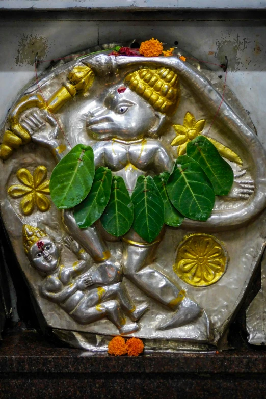 there is an idol on a stone with leaves