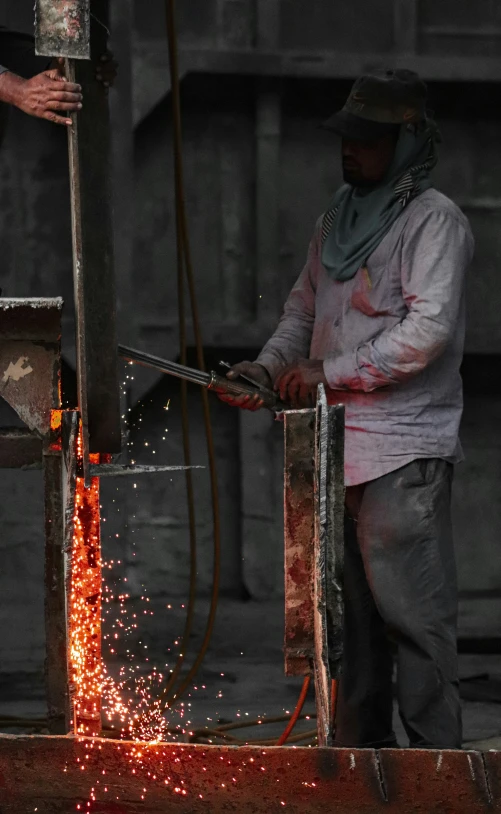 a person standing over an object being worked on