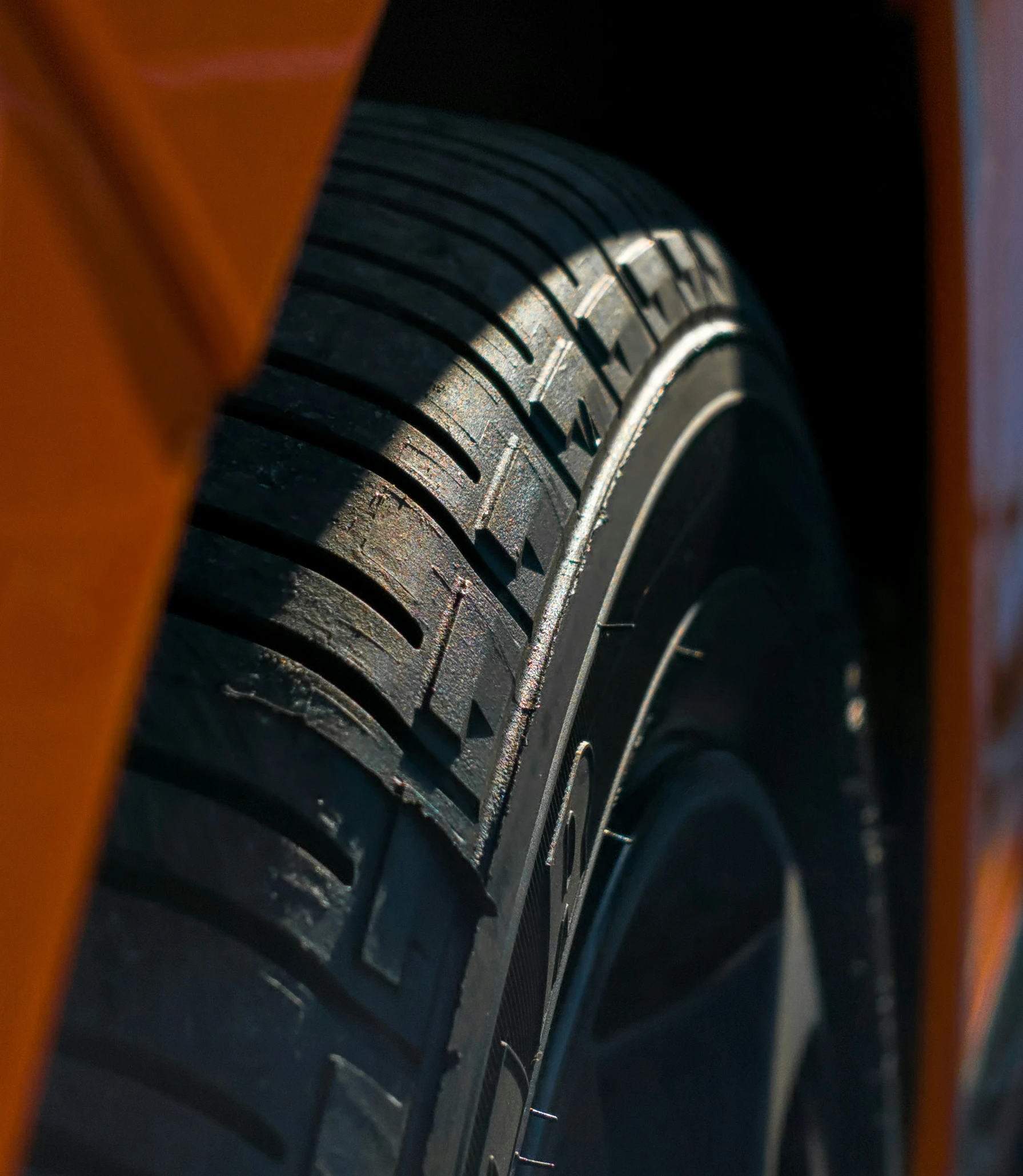 a close up s of a tire with a light brown background