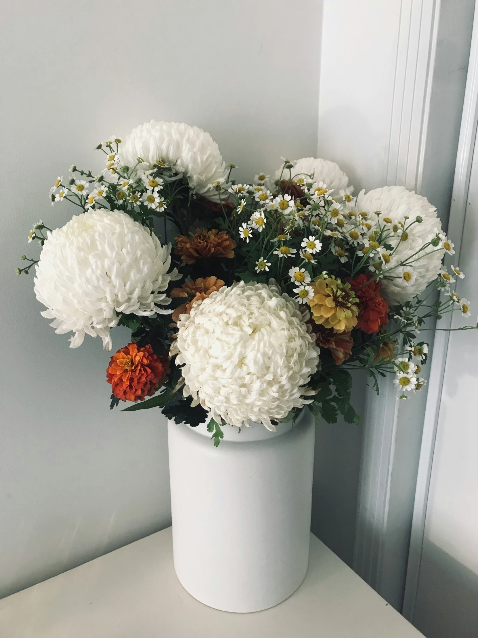this is a white vase with flowers inside