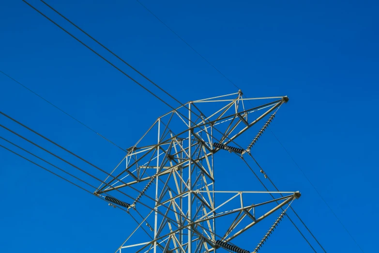 a large metal tower with many electrical wires