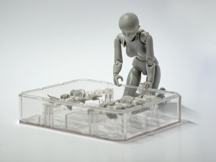 a plastic figurine that looks like he is trying to fix a device