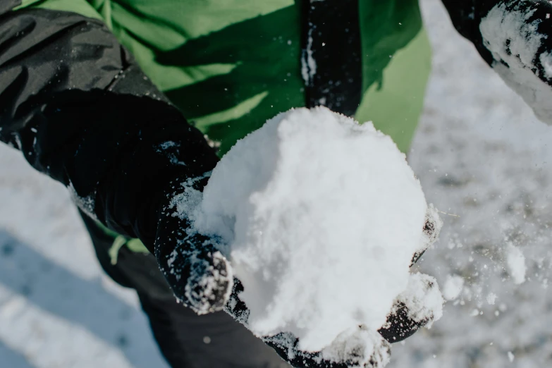 there is snow on the persons hand in the snow