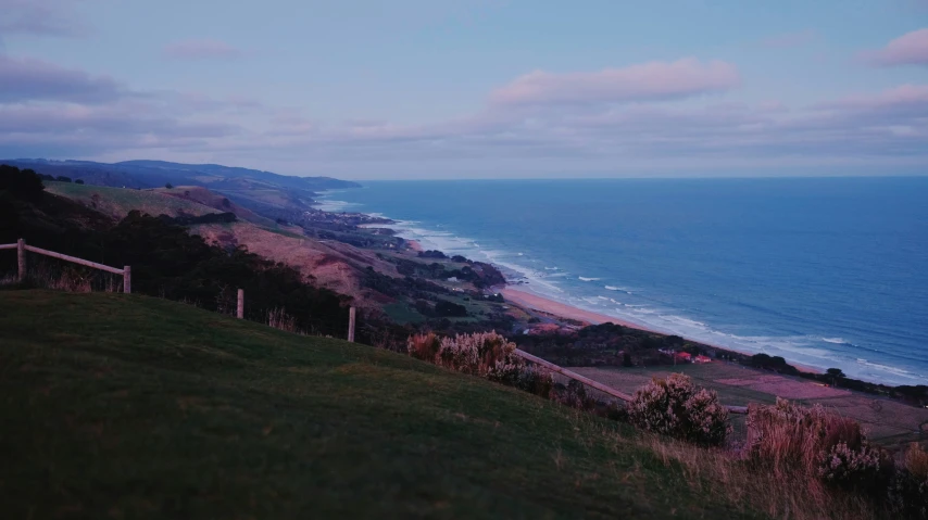 an aerial view of a coastal hillside on a cloudy day