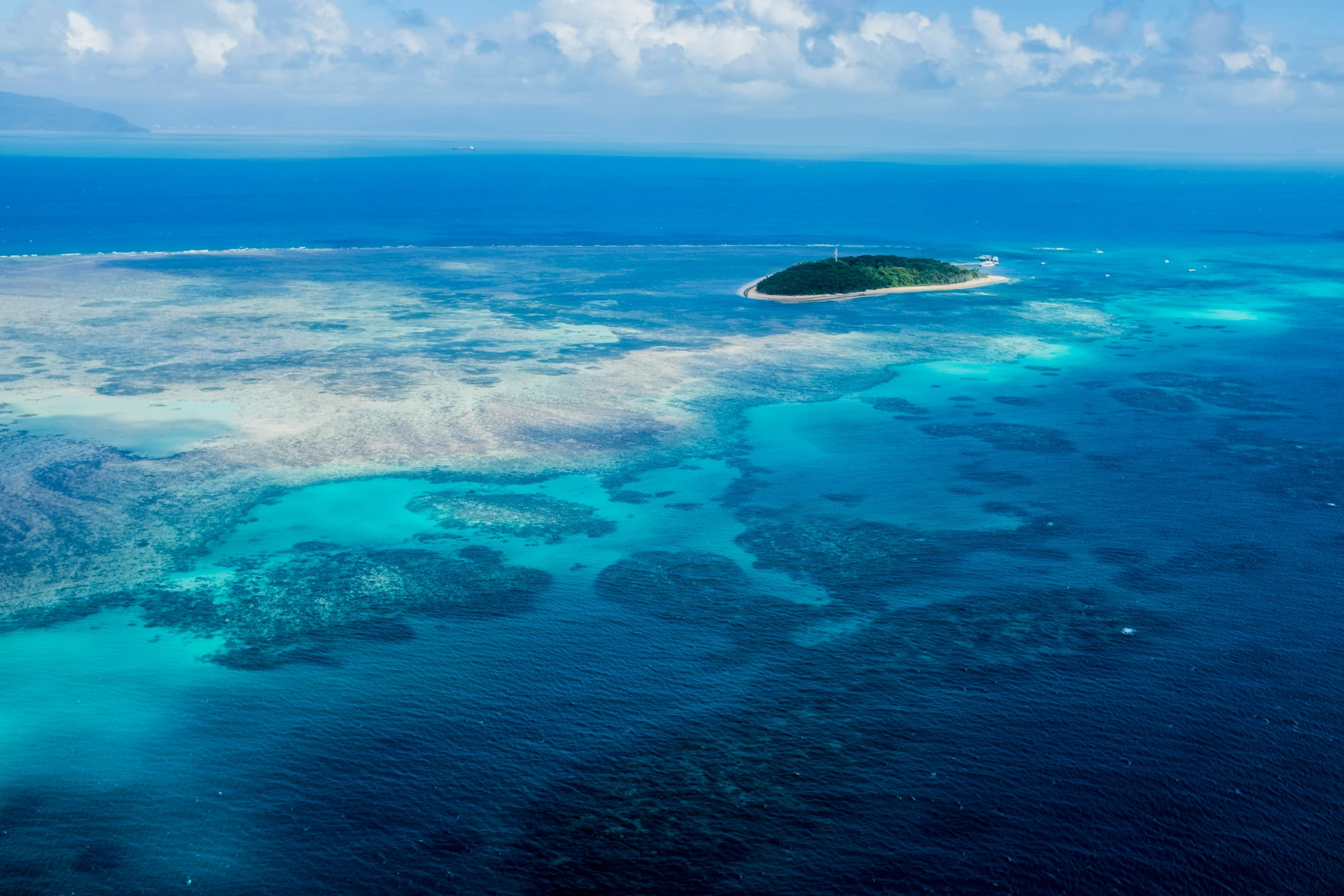 aerial view of blue lagoon with large island