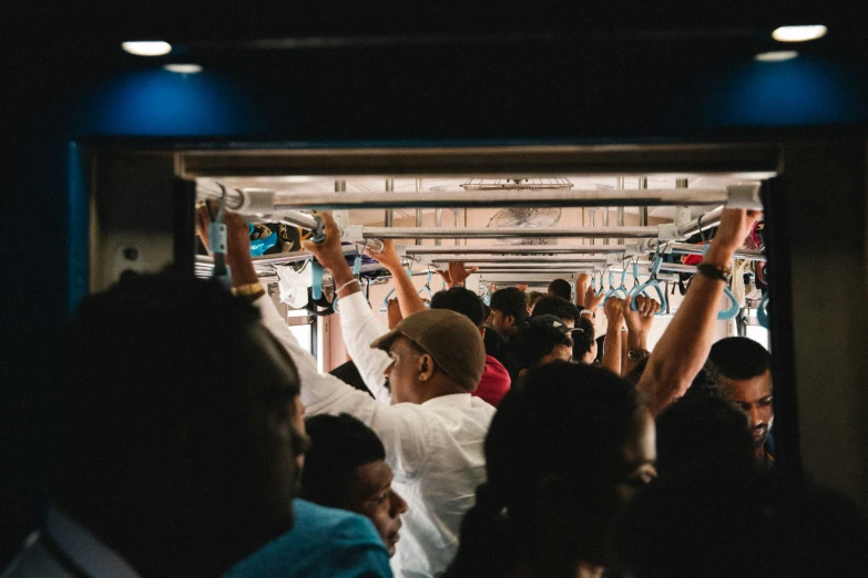 people are waving while riding on a subway train