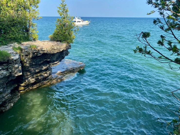 a boat is going along the ocean water