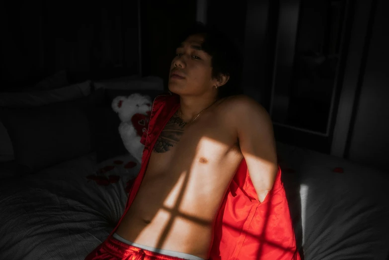 a person in red clothes sitting on a bed