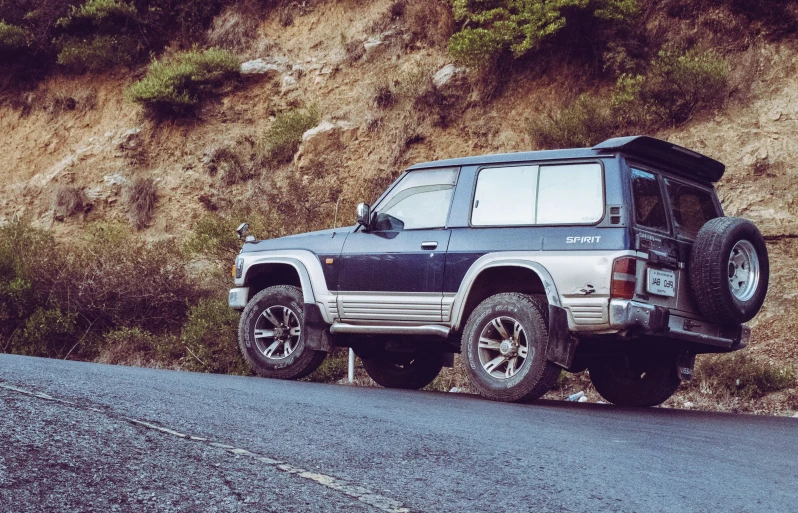 the front of a vehicle parked on the side of a hill