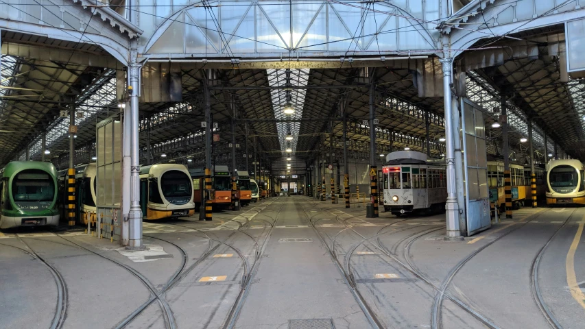 two train platforms at a train station with the trains on their tracks