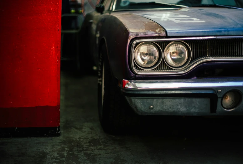 an old car is seen parked in the garage