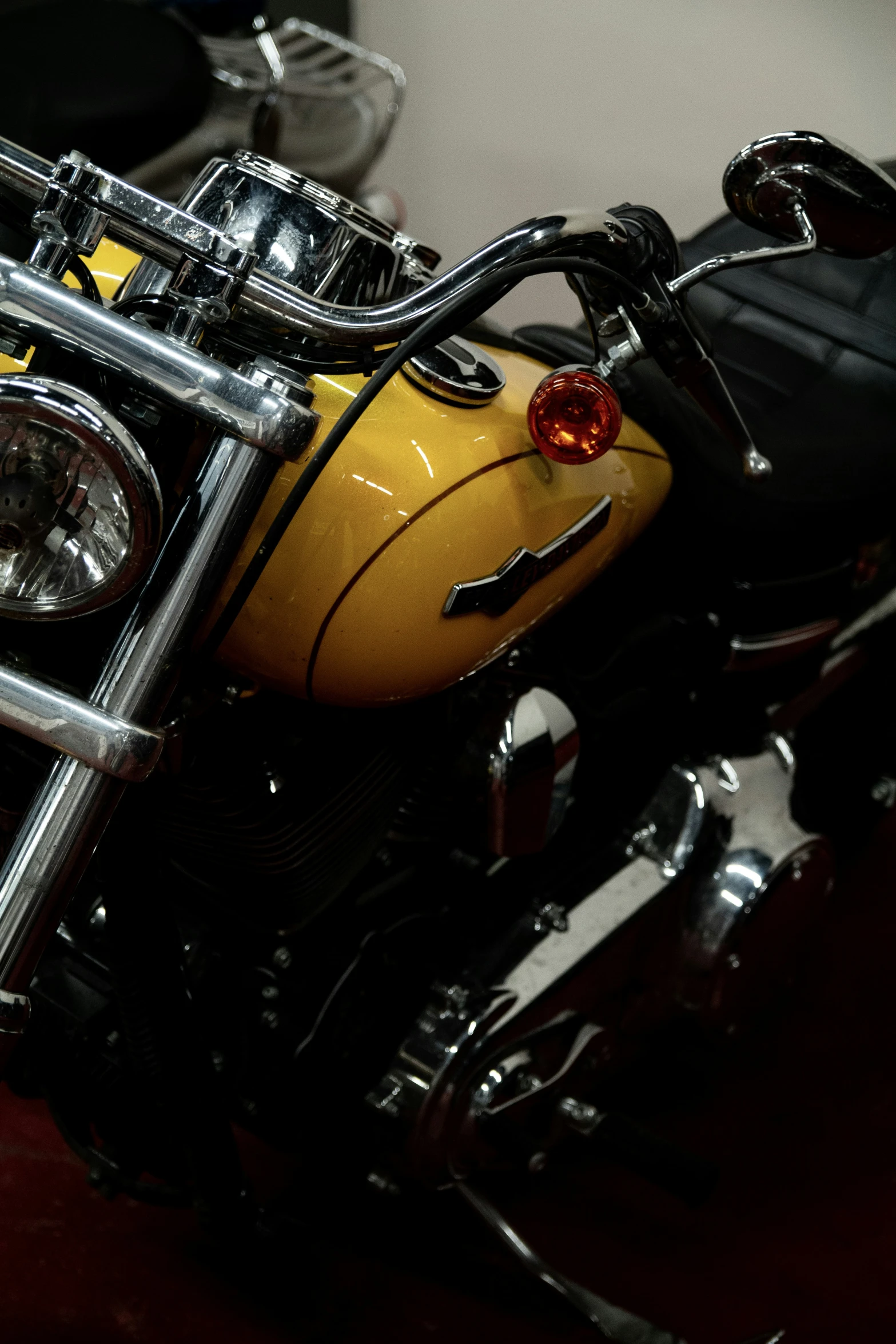 a parked motorcycle sitting on top of a wooden floor