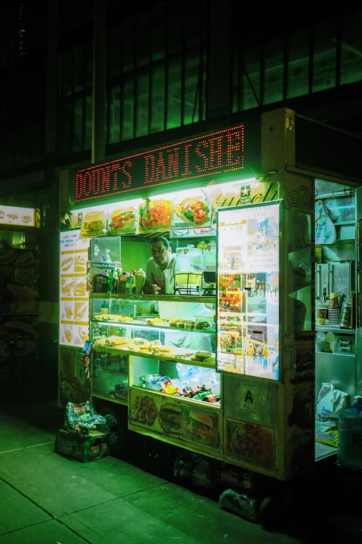 some kind of food cart that is lit up at night