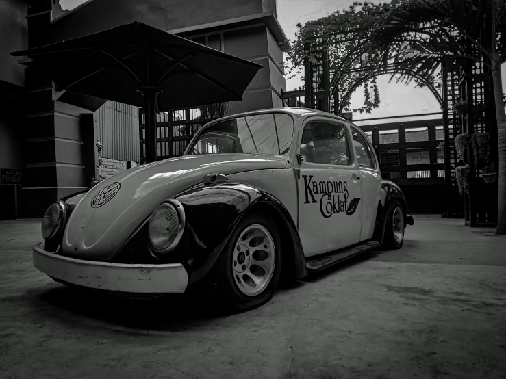 black and white po of an old vw bug with a kootee coffee on it