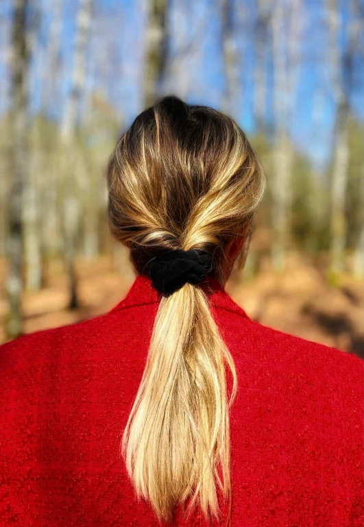 the back of a woman's head wearing a red coat