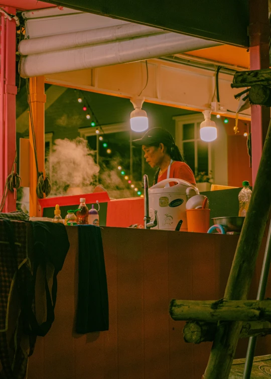 a food vendor is serving out  food to his customers