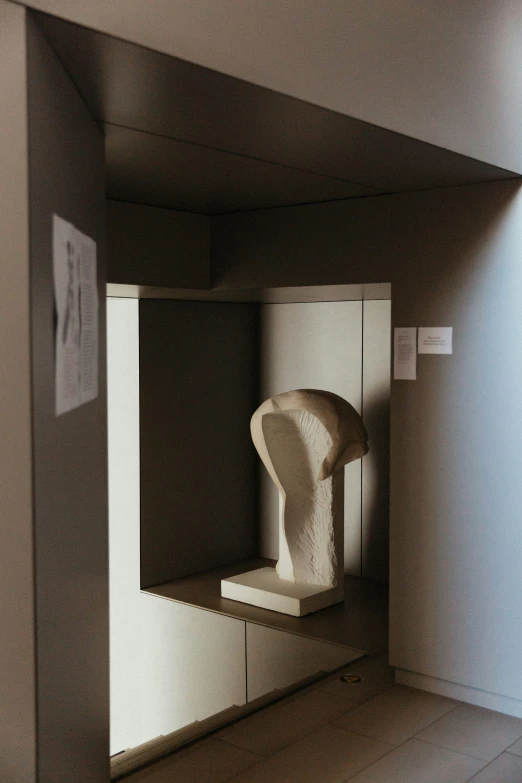 a sculpture in the corner of a room