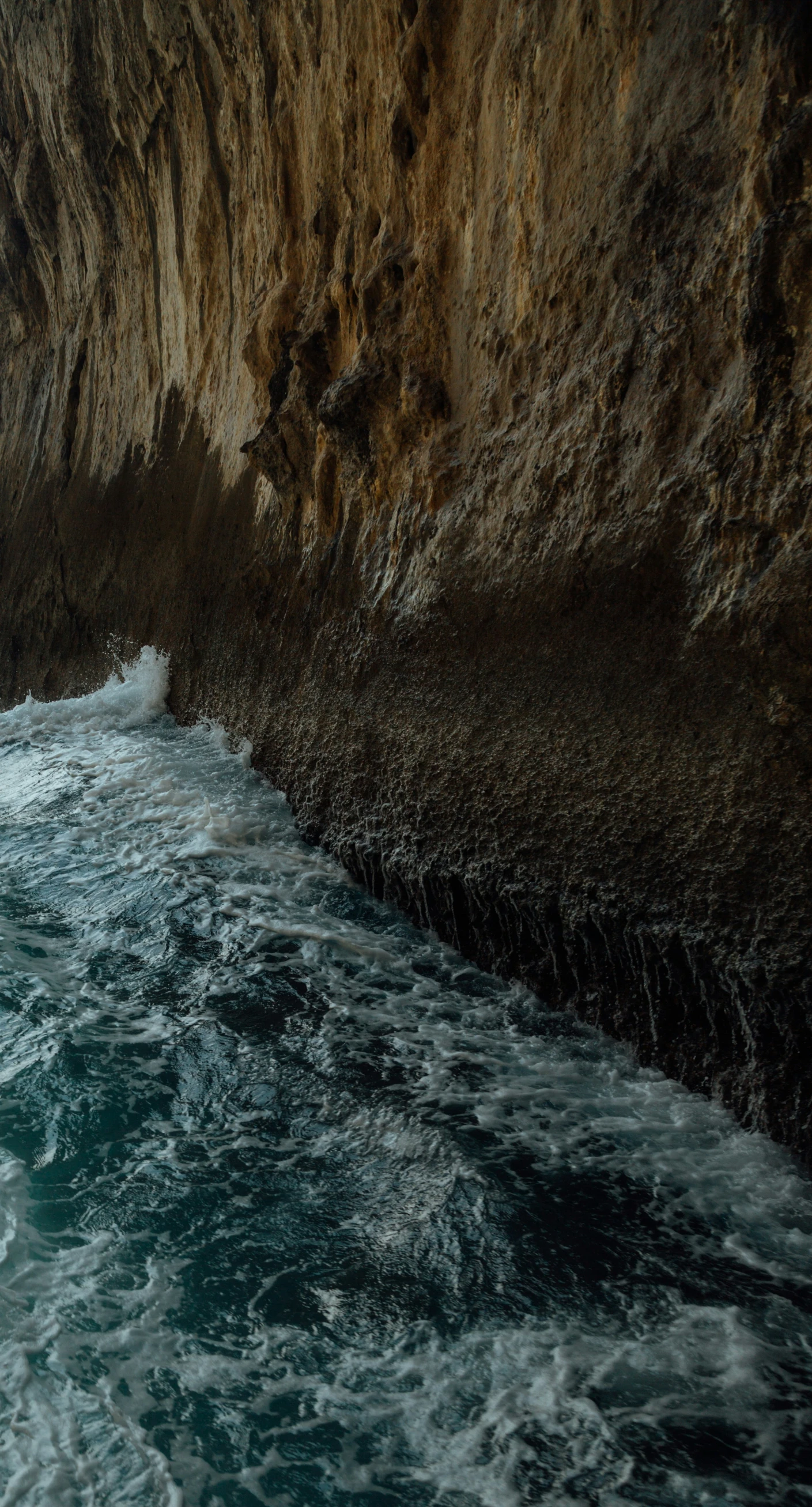 two boats are coming towards the shore, and the waves have crashed