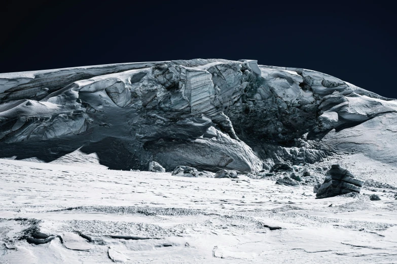 a large snow covered rock formation near the ski slope