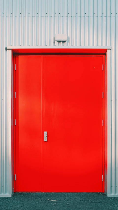 the bright red door is next to the silver wall