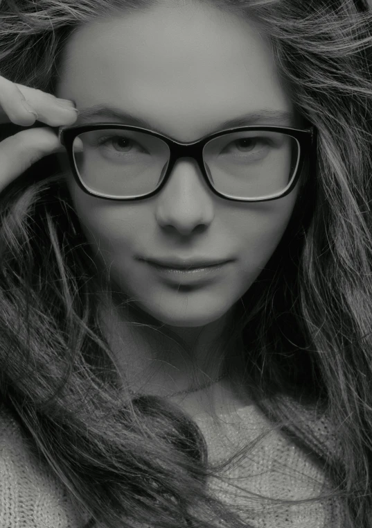 black and white po of woman with glasses posing