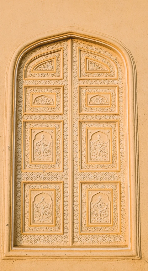 an ornate door with a window above it