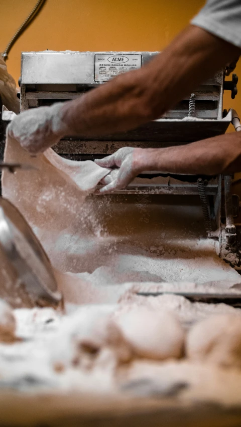 a man puts bread into a loaf that he holds