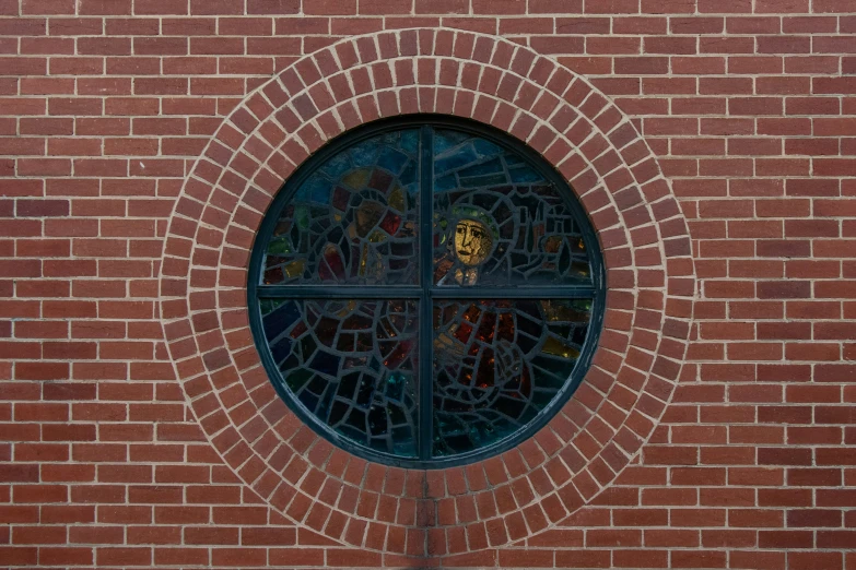 a circular window on the wall of a building