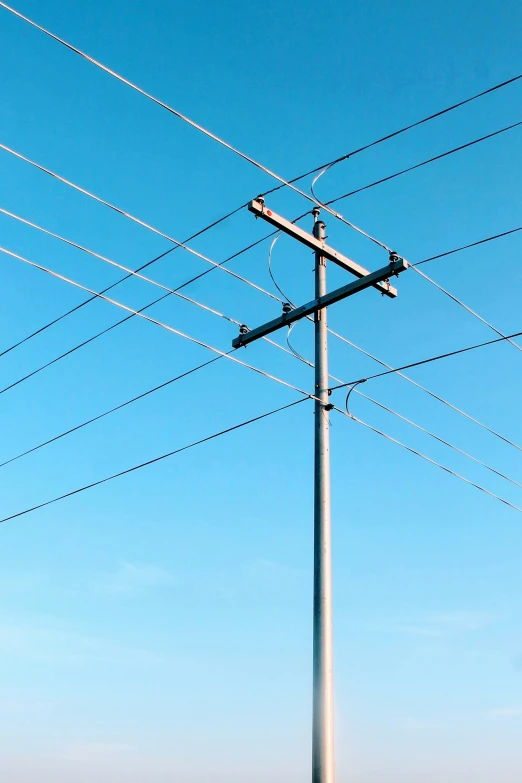 a road intersection under electrical wires and power lines