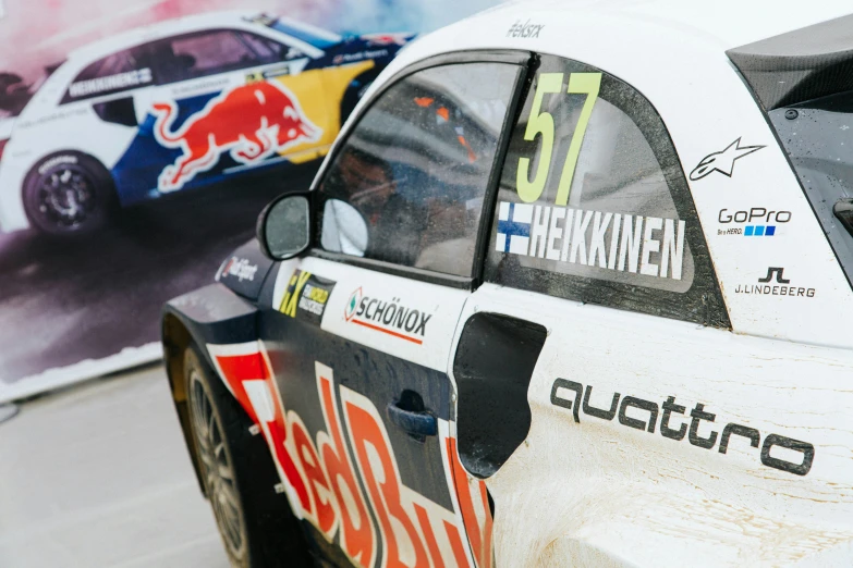 two rally cars on a track near each other