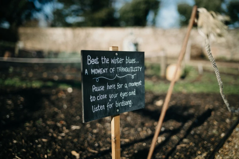 a sign posted in an old garden is saying better be the kind that makes a moment of tranquility