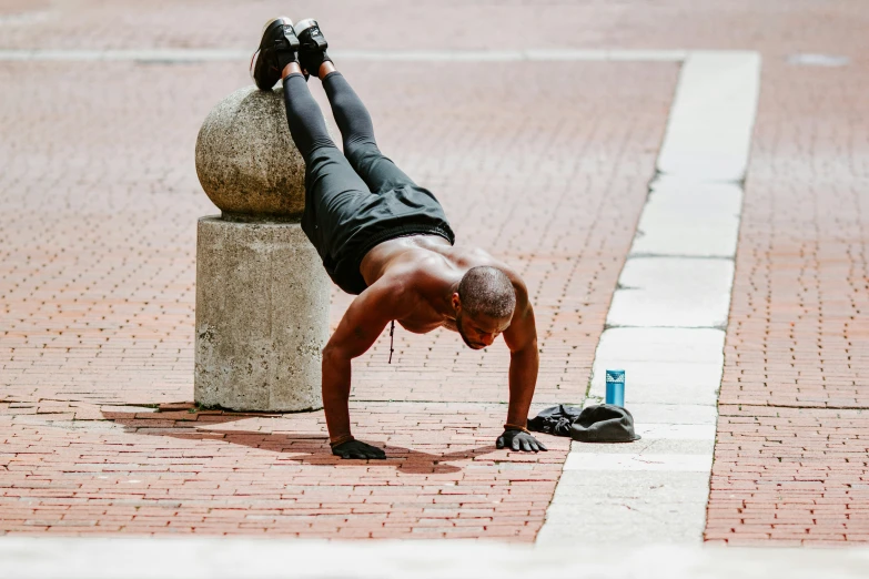 a man doing a handstand on a bench