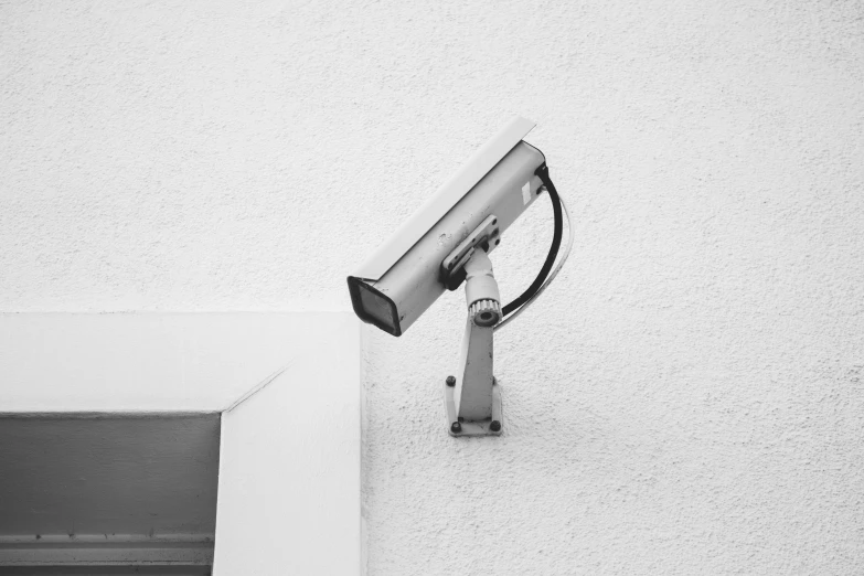 the black and white po shows a security camera in front of a building