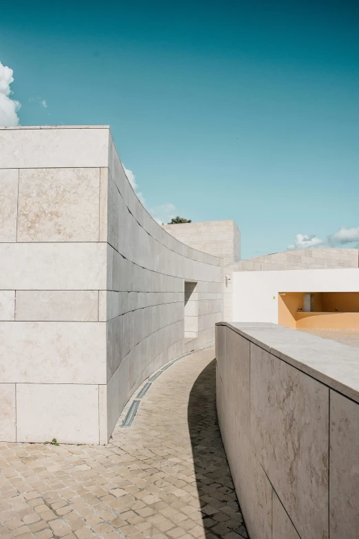 the walkway is next to the cement blocks