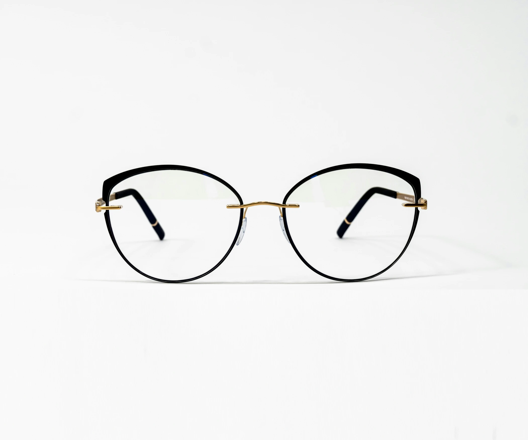 glasses that are black and gold with one pair of glasses